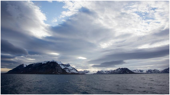 Sea water with mountains in the back
