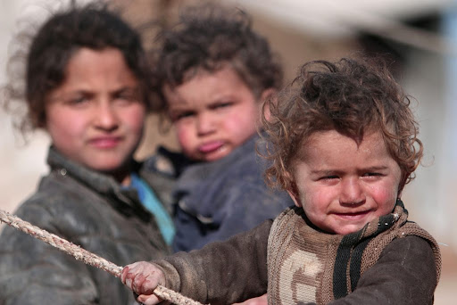 Children in Syria playing near their tent for those who are displaced by the war