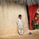 Afghan children leaning against a wall
