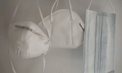 Three covid-19 masks hanging on a stand