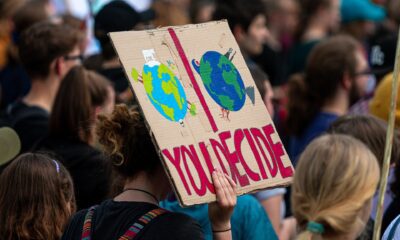 Women holding up a sign at a climate change rally.