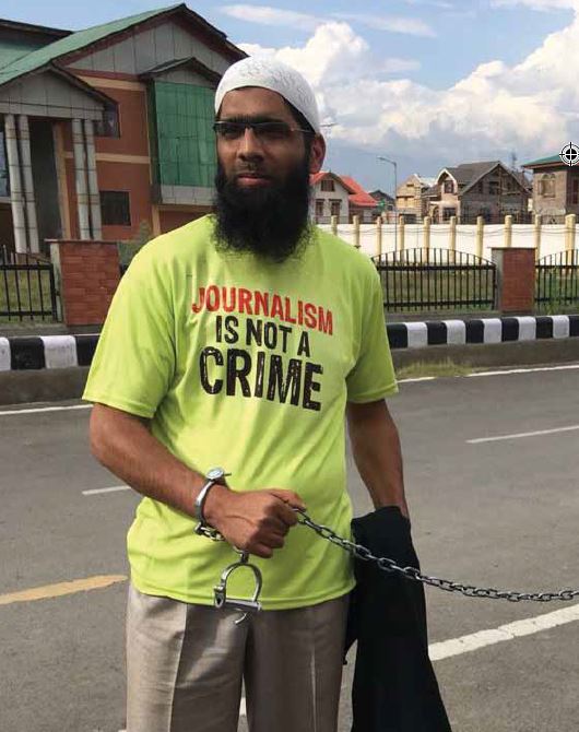 Protestor wearing "Journalism is not a crime" shirt.