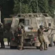 Israeli soldiers getting out of a military vehicle