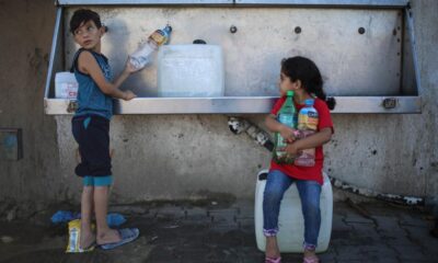 children filling up water bottle from a clean water source