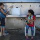 children filling up water bottle from a clean water source